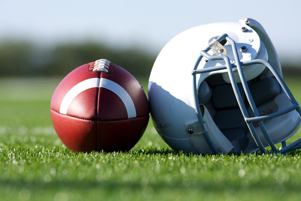 American Football and Helmet on the Field